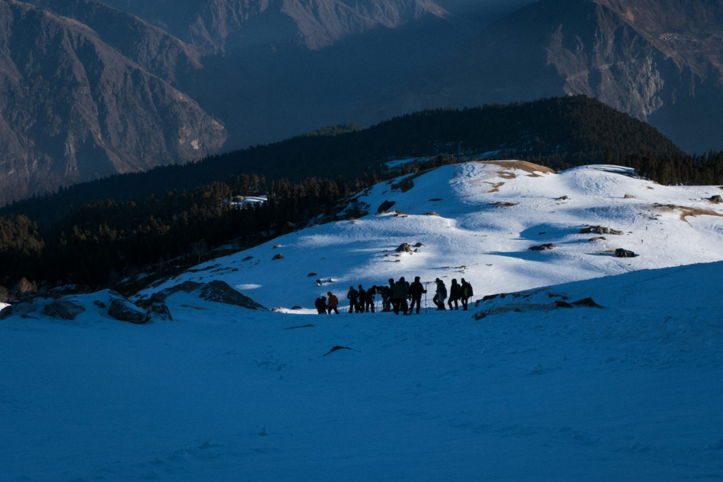 Winter trekking in India with group of trekkers in Himalayas