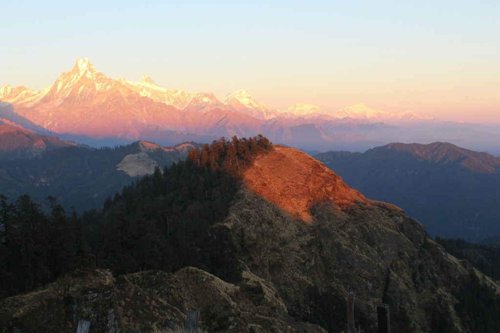 Trekking in India with golden sunrise over Himalayan mountain peaks